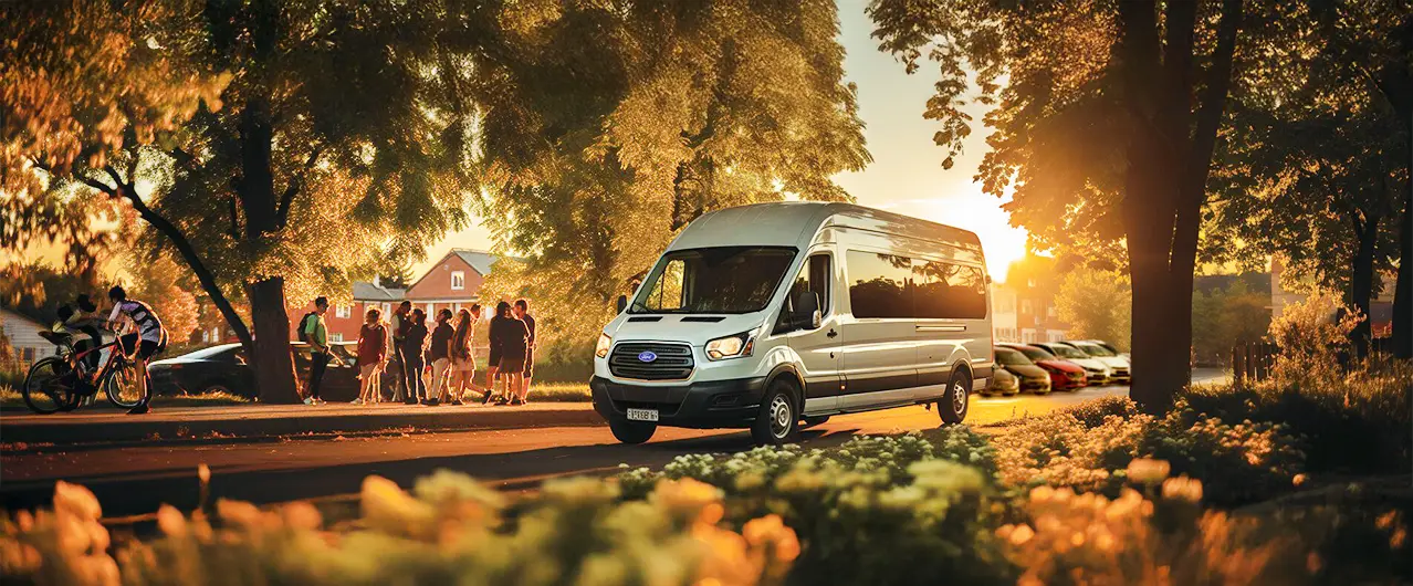white shuttle bus on the street with children waiting to get on the bus