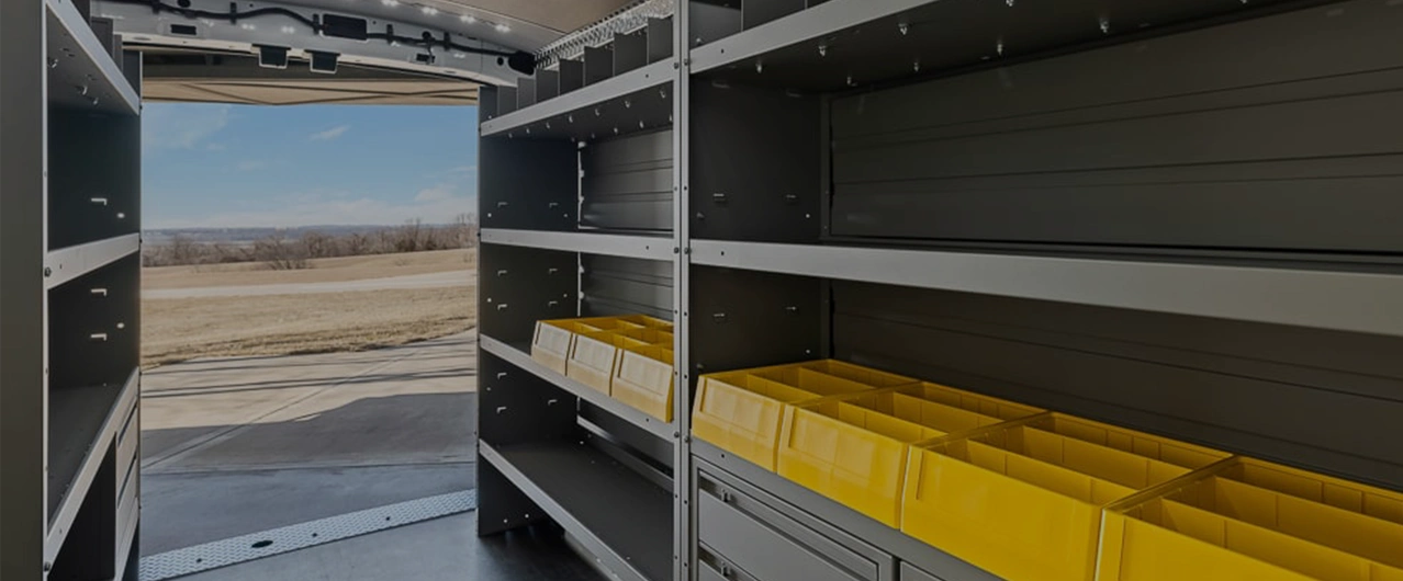 a man putting items away in an upfitted truck