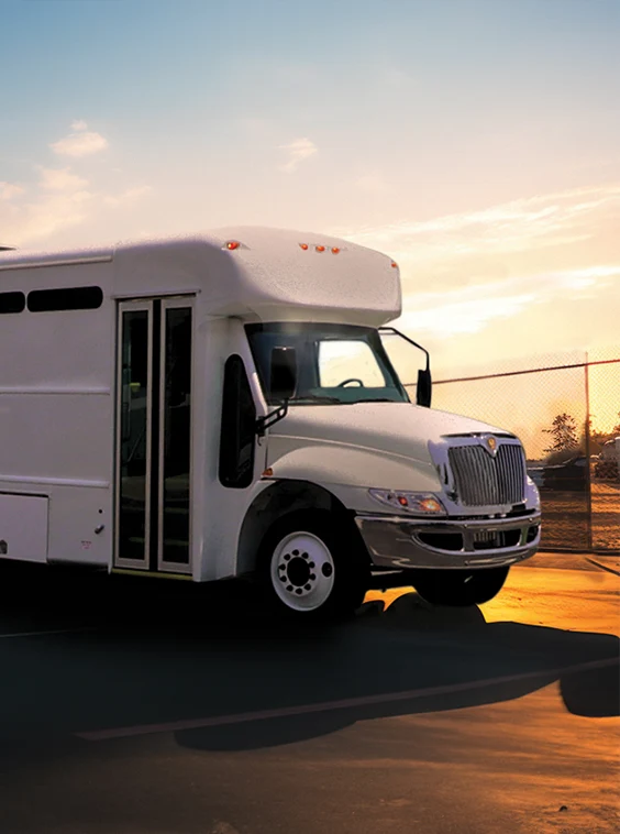 White shuttle bus parked next to a security fence at a prison near Elkhart